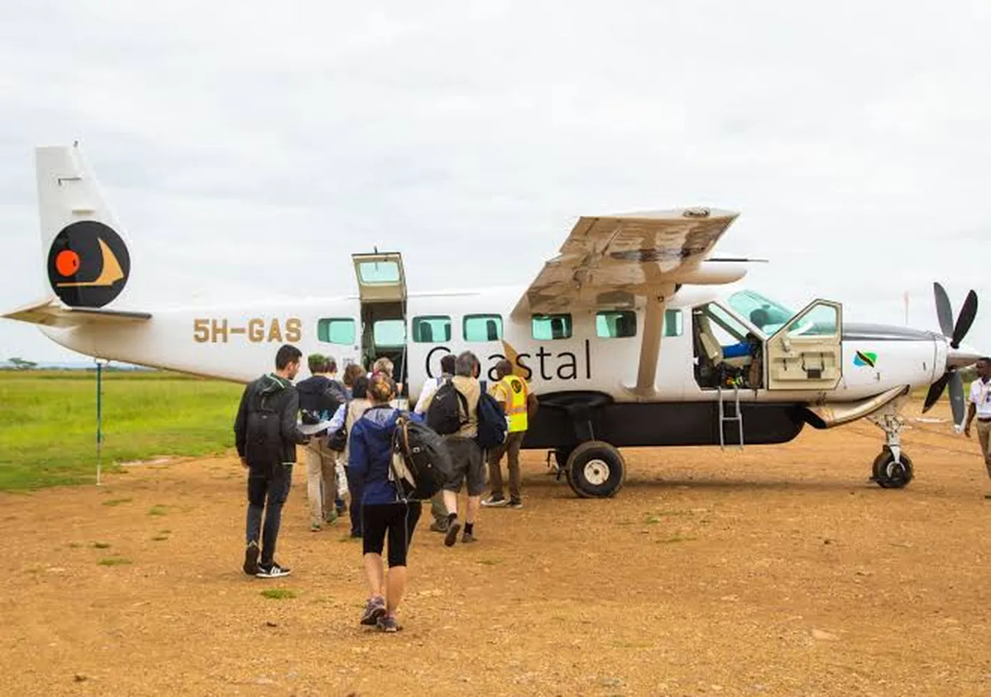 How to book Coastal Aviation for 6 days safari - Cessna bush airplane sitting on a dirt airstrip in Serengeti