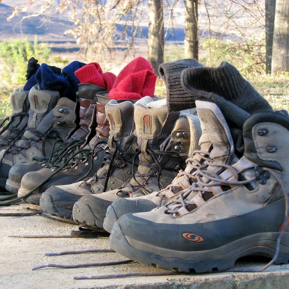 How to choose the best hiking boots for Mount Kilimanjaro Uhuru Peak showing premium leather and synthetic waterproof trekking footwear