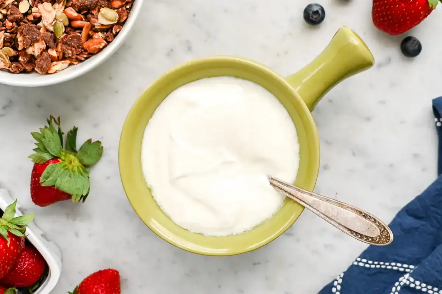 Homemade yogurt jars set on a kitchen counter