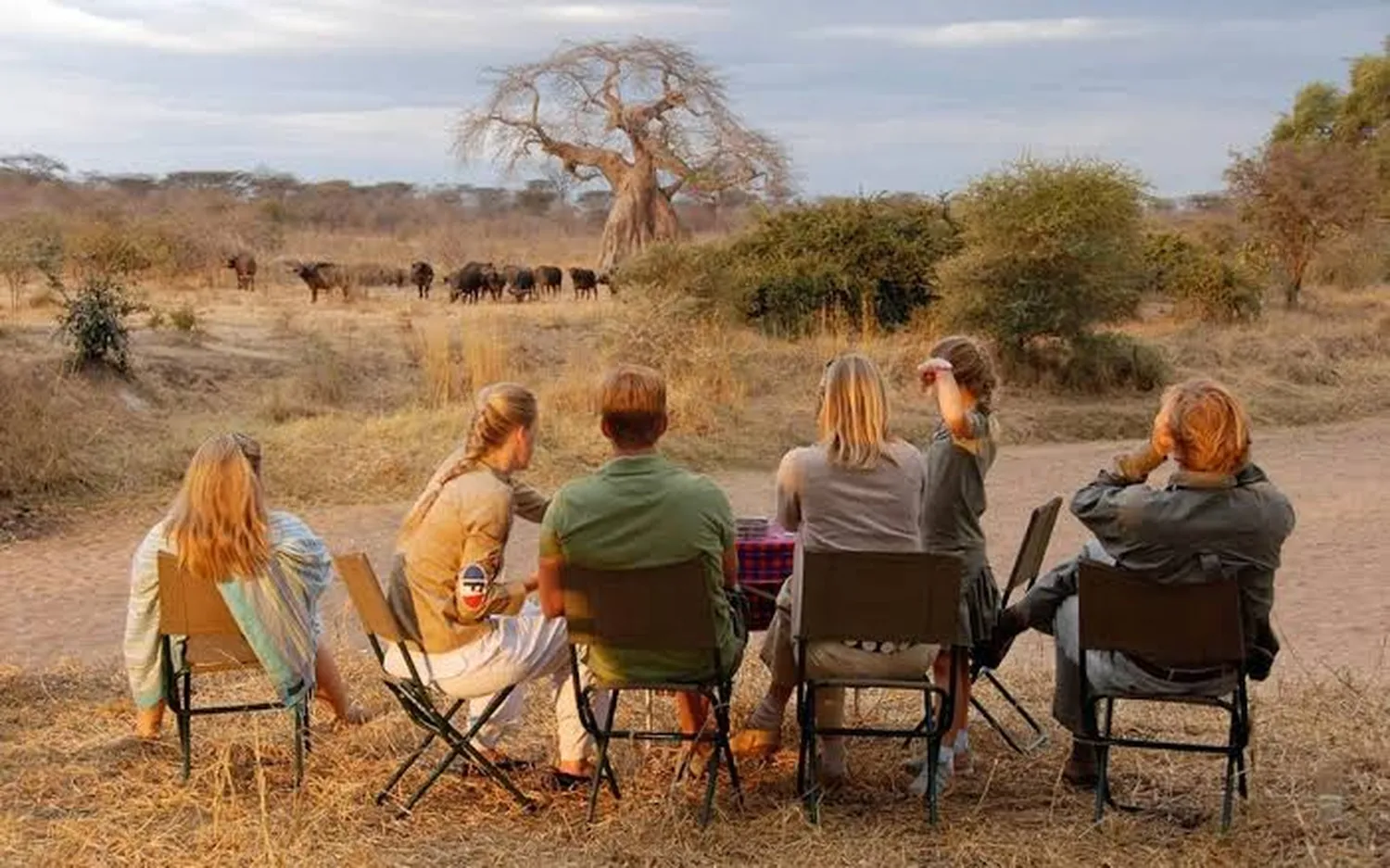 Safest and most comfortable travel months for a Tanzania family safari - Happy family watching wildlife